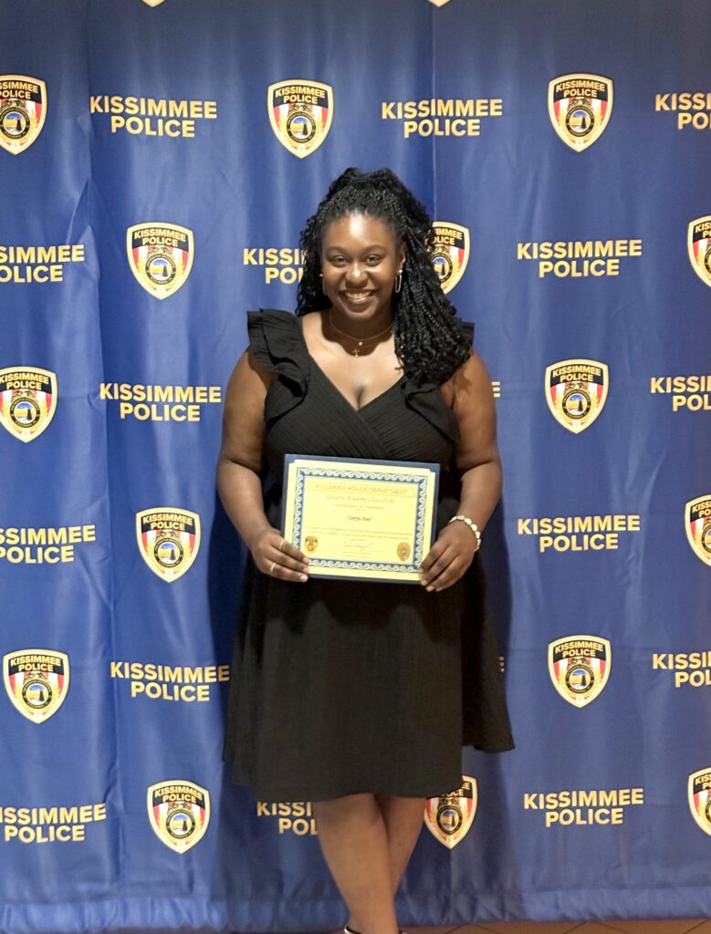 Picture of Tamyia holding a certificate at her KPD Citizens' Academy graduate.
